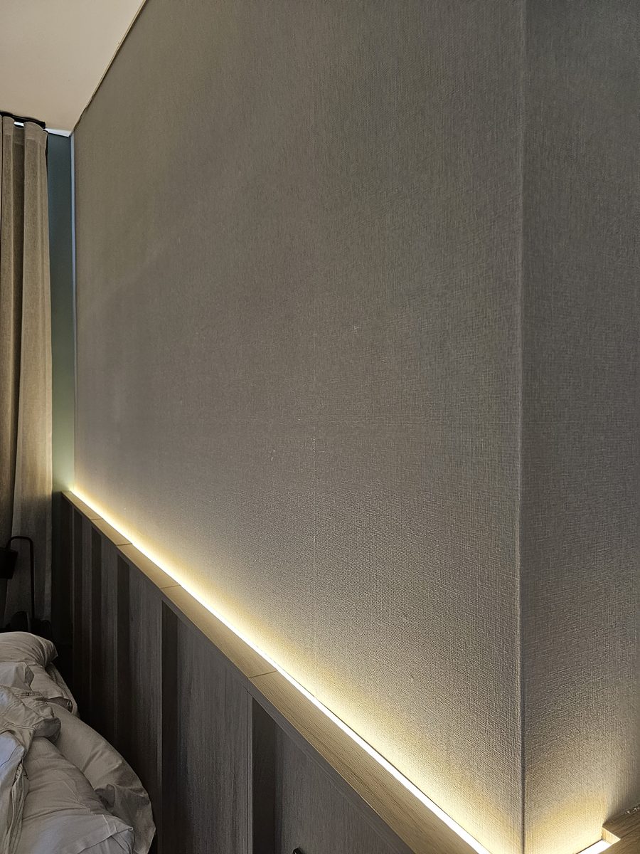 Concealed LED lighting above a timber bedhead in a finished room at Bimbadgen — The Lane Retreat