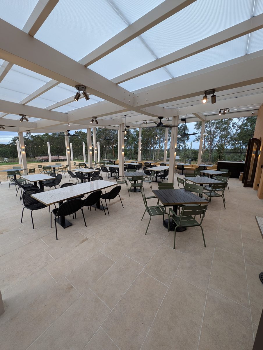 Pergola track spotlights along beams, daytime